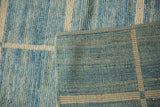 Textured blue and ivory pile of an Afghani modern carpet with woven geometric back.