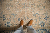 Distressed vintage Mehrivan rug's ivory field, with beige and powder blue geometric guls.