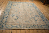 Distressed vintage Mehrivan carpet, sapphire blue meandering palmette border and ivory field.