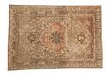 Distressed vintage Malayer rug with a large center medallion, showing heavy abrashes in terracotta and ivory tones.