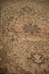 Angled close-up showing heavy abrashes across the terracotta medallion and cream field.