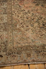 Corner of a vintage Malayer rug with heavy abrashes and wear to the hand-knotted pile.