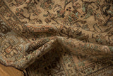 The hand-knotted texture and even wear of a distressed Malayer rug in earthy, time-softened tones.