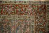 Detail of the worn Turtle Samovar and Herati motifs on the corner of a vintage Tabriz carpet.