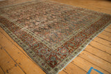 Angled shot of a distressed Tabriz corner, detailing the patinated Herati field and red Turtle Samovar border.