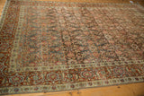 A long perspective of the vintage Tabriz carpet highlights its textural allover design and wear.