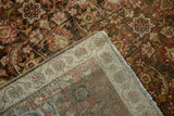 Hand-knotted construction visible on the back of a vintage distressed Persian Tabriz carpet.