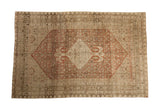 Antique distressed Bijar carpet with a rust stepped medallion on a worn Herati field in ivory and beige tones.