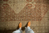 Evenly worn texture and time-softened rust and ivory colors on an antique distressed Bijar carpet.