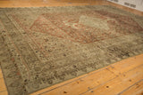Angled view across the time-softened Herati field and border of a distressed antique Bijar carpet.
