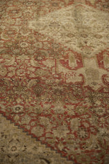 A close view of the antique Bijar's distressed pile, worn evenly to the knot heads.