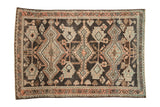 Distressed Hamadan rug: charcoal, ivory, dusty cantaloupe geometric medallions and vine patterns.