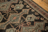 Distressed Hamadan rug detail, showing geometric design, worn knot heads, and dusty melon tones.
