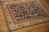 Distressed Caucasian rug detail: navy, blush geometric patterns and starburst border.