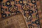 Folded antique Caucasian rug displays distressed geometric pattern, selvage, and backing.