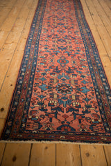 Vintage Mehrivan runner close-up: blush red geometric field with sapphire blue boteh border.