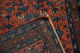 Folded Mehrivan runner corner reveals hand-knotted blush red field, sapphire boteh border, and fringe.