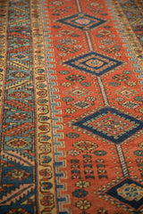 Angled view of the low pile on a Persian runner's sapphire blue medallions and geometric borders.