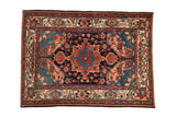Vintage Bakhtiari rug with a navy blue medallion, red and teal florals, and intricate corner spandrels.