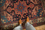 A close view of the vintage Bakhtiari rug's even wear and vivid floral patterns.