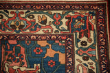 Intricate corner spandrel of a hand-knotted Bakhtiari rug with vivid red and blue blossoms.