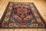High angle view of a vintage Bakhtiari rug, emphasizing its traditional geometric medallion and colorful floral field.