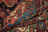 Hand-knotted texture and vivid floral pattern on a folded section of a vintage Bakhtiari rug.