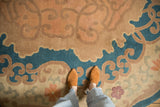 Detail of antique Chinese Arts and Crafts rug; scrolling vines and blossoms in denim blue, beige, and pale mauve.