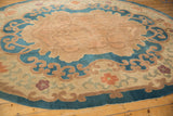 Antique Chinese Arts and Crafts rug: dusty blue border, beige serrated leaf, pale blossoms.