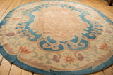 Antique Chinese Arts and Crafts rug with serrated leaf border and pale blossoms.