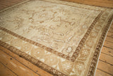 Distressed vintage Kars rug corner, showcasing machine bound side and muted ivory floral patterns.