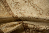 Soft, distressed texture of a vintage Turkish Kars rug, showing faded floral sprays in neutral tones.