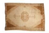 Vintage Kars carpet with an octagonal medallion and stepped spandrels in distressed shades of sand and bronze.