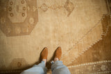 A personal view of the vintage Kars carpet's low-pile texture and sandy beige color.