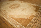 Bronze-brown stepped corner spandrels and floral border on a distressed vintage Kars carpet.