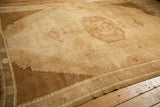 Textural wear and bronze-brown abrashes on the stepped spandrels of a vintage Kars carpet.