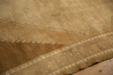 Worn hand-knotted texture of a distressed Kars rug showing stepped geometric lines.