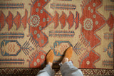 Hand-knotted pile detail of an antique Bakshaish carpet with red and blue finned floral motifs.