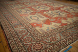 Angled view of an antique Bakshaish corner with a serrated leaf border and time-softened pile.