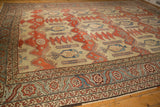 Angled view across the antique Bakshaish carpet's field, showing the ivory ground and finned designs.