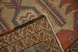 Folded corner of an antique Bakshaish showing the hand-knotted weave and dark brown selvage.