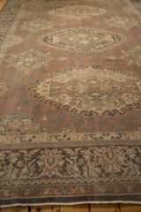 Distressed vintage Sparta rug showing soft madder root red, ivory, and slate blue patterns.