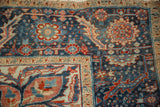 Detailed floral border and distressed navy pile on a vintage Persian Ahar carpet corner.