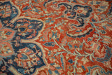 Low pile texture of a vintage Ahar carpet with brick red and navy blue floral scrolls.