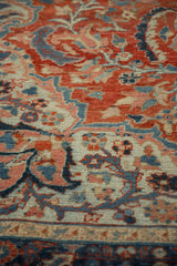 Close-up view of the distressed Ahar carpet's low pile and scrolling floral pattern.