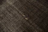 Scattered ivory serpent embroidery on the dark, abrased ground of a vintage Turkish Kilim.