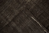 Folded corner of a Turkish Kilim showing the dark brown flat weave and secured side selvage.
