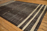 Textured charcoal black vintage Kilim ground with ivory stripes and subtle wave embroidery.