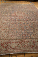 Vintage distressed Tabriz carpet border showcasing spiraling vines, slate blue, and cherry red.