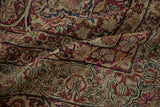 The storied, low-pile texture of an antique Kerman with its visible hand-knotted foundation.
